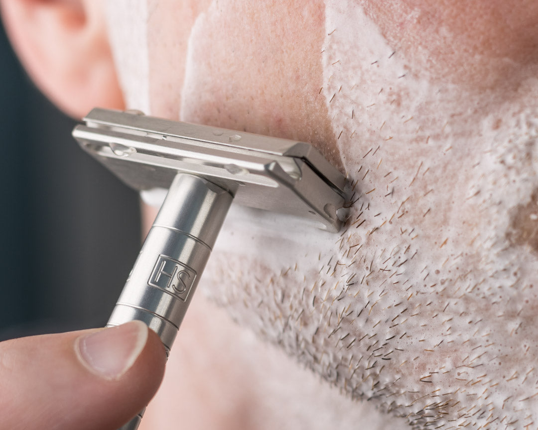 Closeup of a man shaving his face